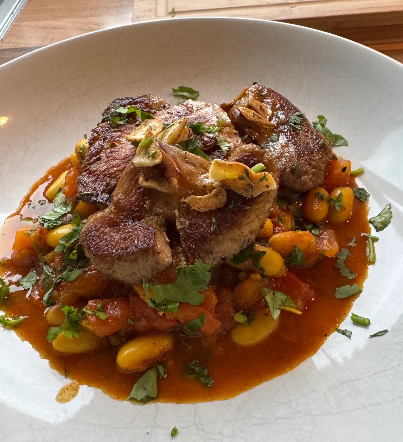 Caramelised lion's mane over smoky beans