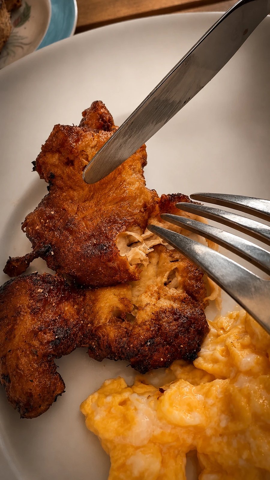 Fibrous strands of seared Popped Lion's Mane pulled apart with a fork